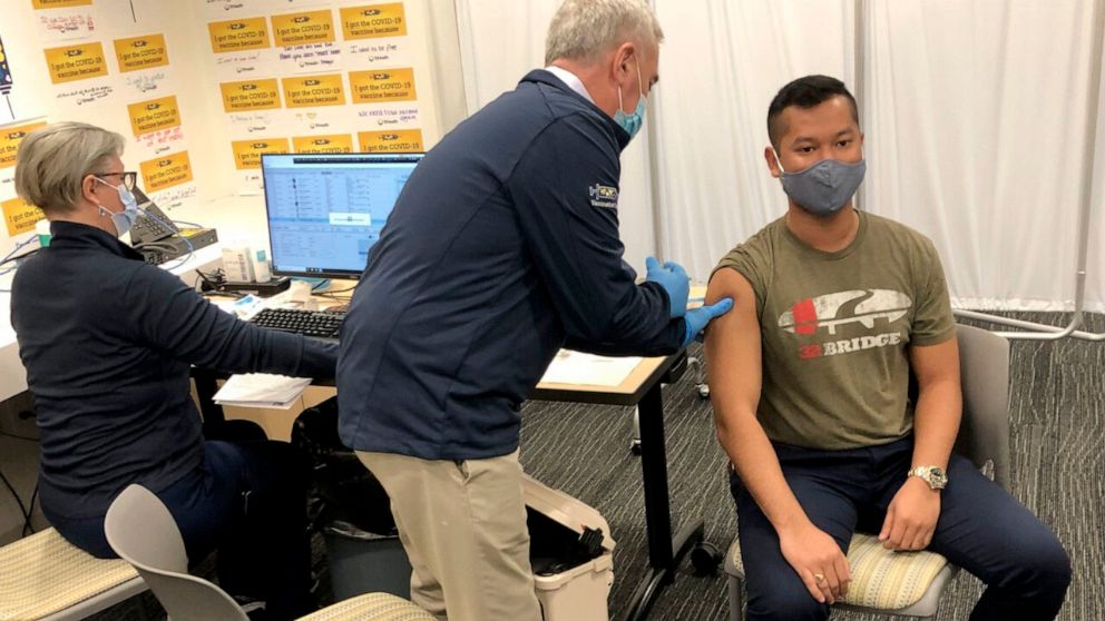 PHOTO: Rep. Brad Wenstrup administers a COVID-19 vaccine to Eli Livingston with the aid of a doctor, left, at TriHealth clinic, in Norwood, Ohio, on March 28, 2021.