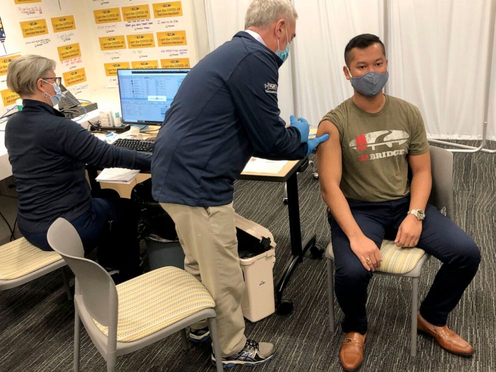 PHOTO: Rep. Brad Wenstrup administers a COVID-19 vaccine to Eli Livingston with the aid of a doctor, left, at TriHealth clinic, in Norwood, Ohio, on March 28, 2021.