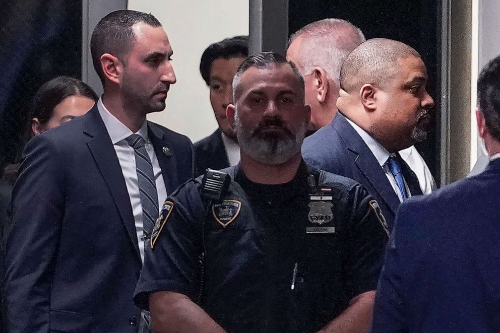 PHOTO: Manhattan District Attorney Alvin Bragg, far right, passes through a hallway outside the courtroom, April 4, 2023, in New York.