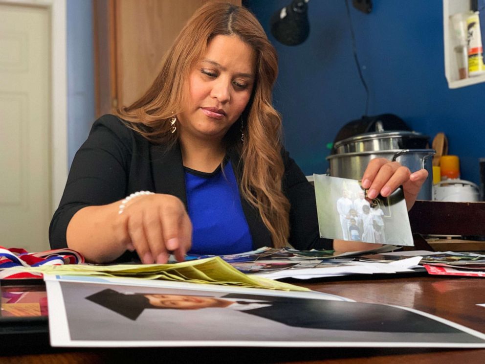Ivon Castillo looks through pictures of her son, Brandon, who was deported from the U.S. after his arrival as a young child nearly 15 years ago.