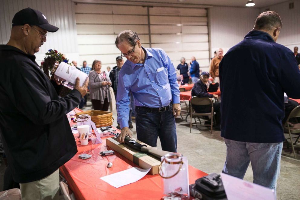 PHOTO: Mike Braun, Republican candidate for Senator in Indiana, inspects a gun at an event in Monticello, Ind., Oct. 18, 2018. 