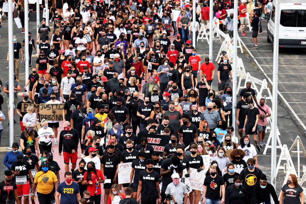 PHOTO: People participate in a march lead by the University of Louisville's Men's basketball team calling for justice for Breonna Taylor, Sept. 25, 2020, in Louisville, Kentucky.