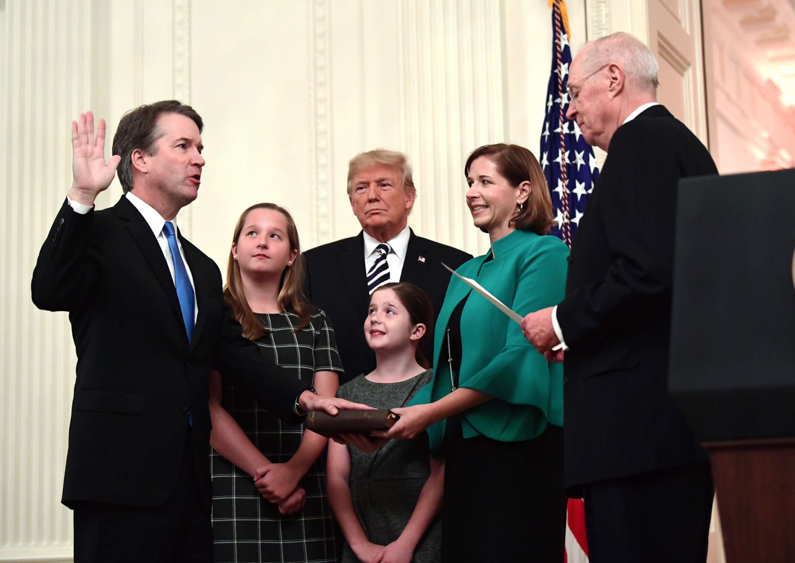 PHOTO: Retired Justice Anthony Kennedy, right, ceremonially swears-in Supreme Court Justice Brett Kavanaugh, as President Donald Trump looks on, in the East Room of the White House, Oct. 8, 2018.