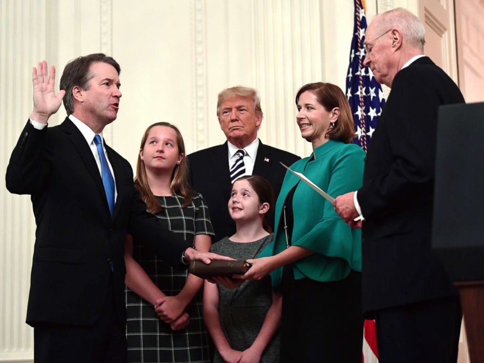 PHOTO: Retired Justice Anthony Kennedy, right, ceremonially swears-in Supreme Court Justice Brett Kavanaugh, as President Donald Trump looks on, in the East Room of the White House, Oct. 8, 2018.