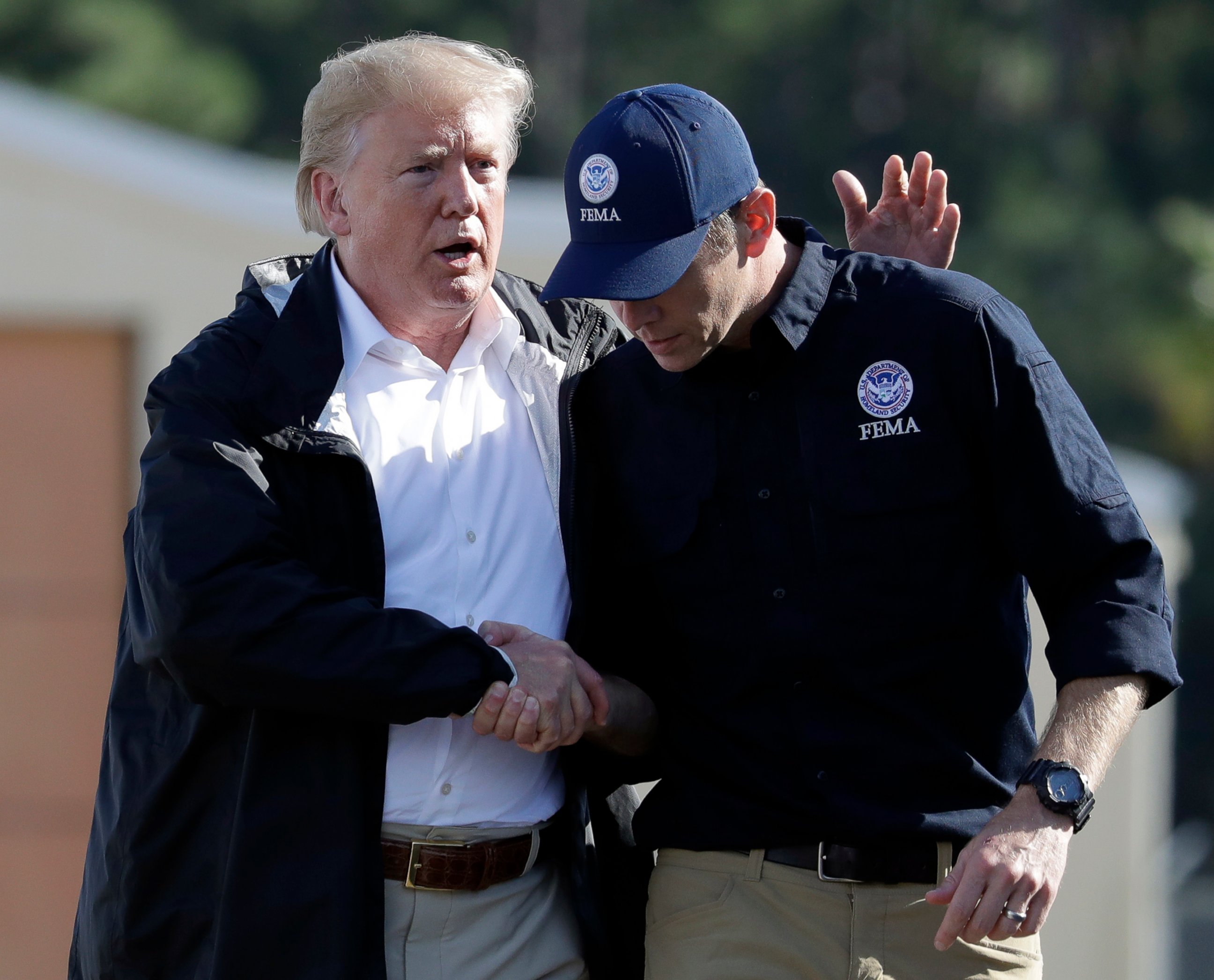 PHOTO: President Donald Trump shakes hands with FEMA Administrator Brock Long after visiting areas in North Carolina and South Carolina impacted by Hurricane Florence, Wednesday, Sept. 19, 2018, at Myrtle Beach International Airport in Myrtle Beach, S.C.