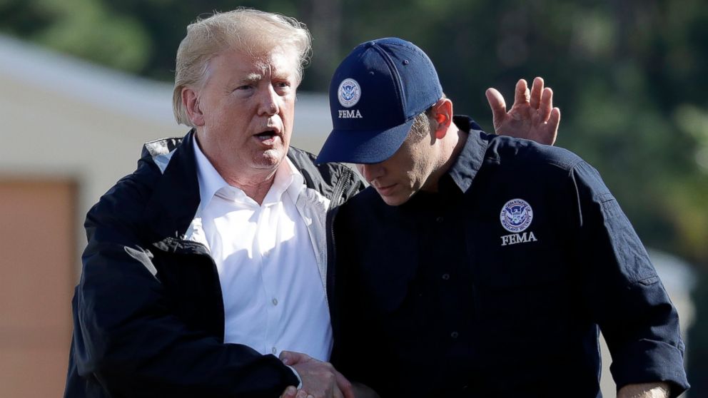 President Donald Trump shakes hands with FEMA Administrator Brock Long after visiting areas in North Carolina and South Carolina impacted by Hurricane Florence, Wednesday, Sept. 19, 2018, at Myrtle Beach International Airport in Myrtle Beach, S.C.