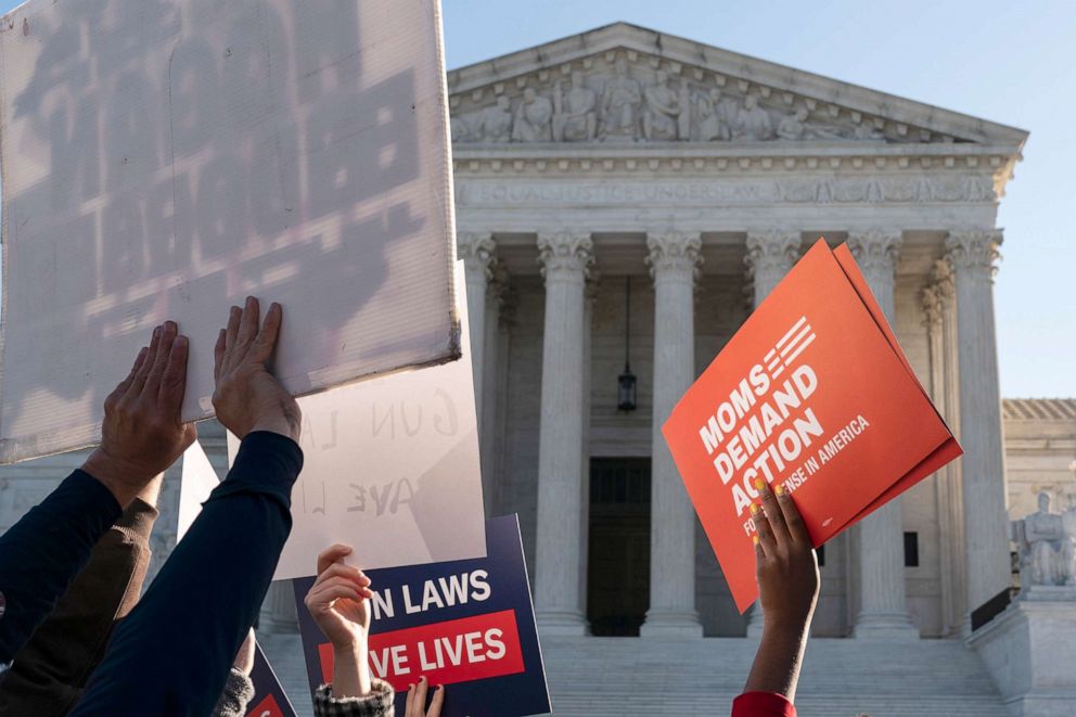 PHOTO: Supporters of gun control hold signs in front of supporters of gun rights during a demonstration by victims of gun violence in front of the Supreme Court as arguments begin in a major case on gun rights in Washington, Nov. 3, 2021.