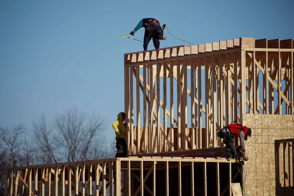 PHOTO: Contractors build the framing of a roof on a house under construction at the Norton Commons subdivision in Louisville, Ky., Feb. 8, 2022. 