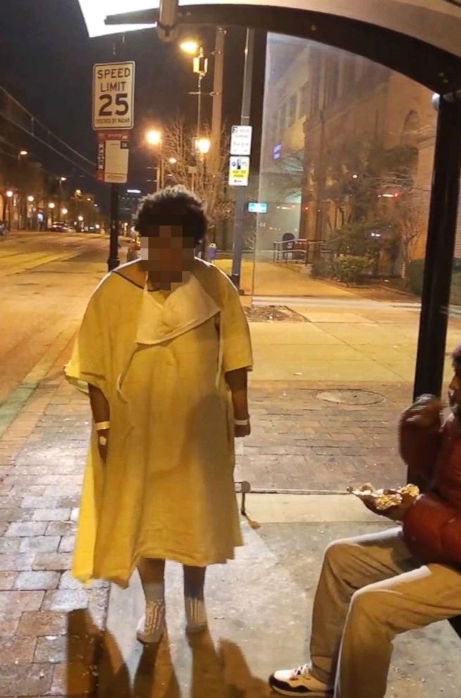 PHOTO: An image taken from video provided by Imamu Baraka shows a woman discharged from a Baltimore hospital at a bus stop wearing only a gown and socks on a cold winter's nigh, Jan. 9, 2018.