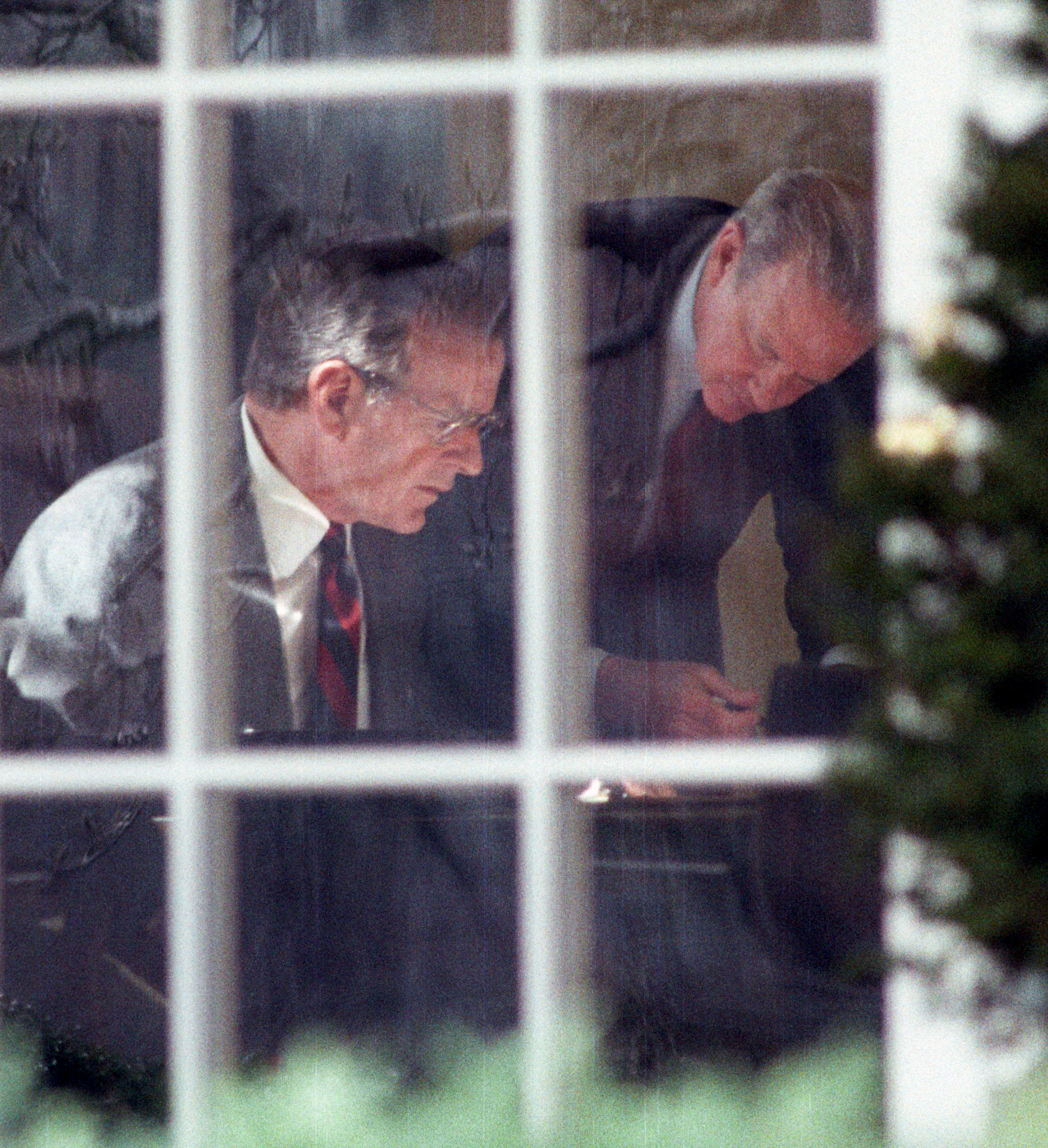 PHOTO: President George H.W. Bush and Secretary of State James Baker study prepared remarks at Bush's desk in the Oval Office, Feb. 22, 1991.