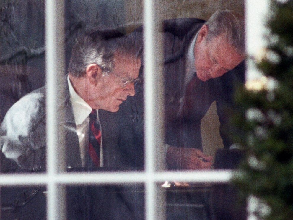 PHOTO: President George H.W. Bush and Secretary of State James Baker study prepared remarks at Bushs desk in the Oval Office, Feb. 22, 1991.