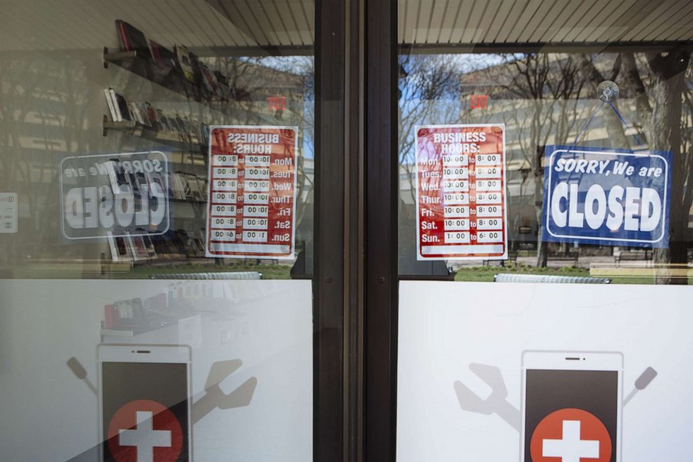 PHOTO: A "Closed" sign hangs in the window of a phone repair shop at The Plaza at Harmon Meadow in Secaucus, New Jersey, April 2, 2020.