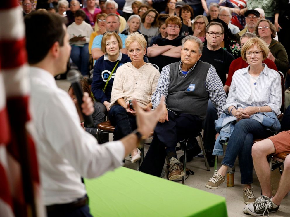 PHOTO: Audience members listen as 2020 Democratic presidential candidate South Bend Mayor Pete Buttigieg speaks during a town hall meeting, Tuesday, April 16, 2019, in Fort Dodge, Iowa.