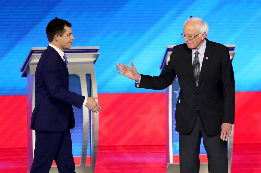 PHOTO: Democratic presidential candidates Pete Buttigieg and Sen. Bernie Sanders greet each other prior to the start of the Democratic presidential primary debate in the Sullivan Arena at St. Anselm College, Feb. 7, 2020, in Manchester, New Hampshire.