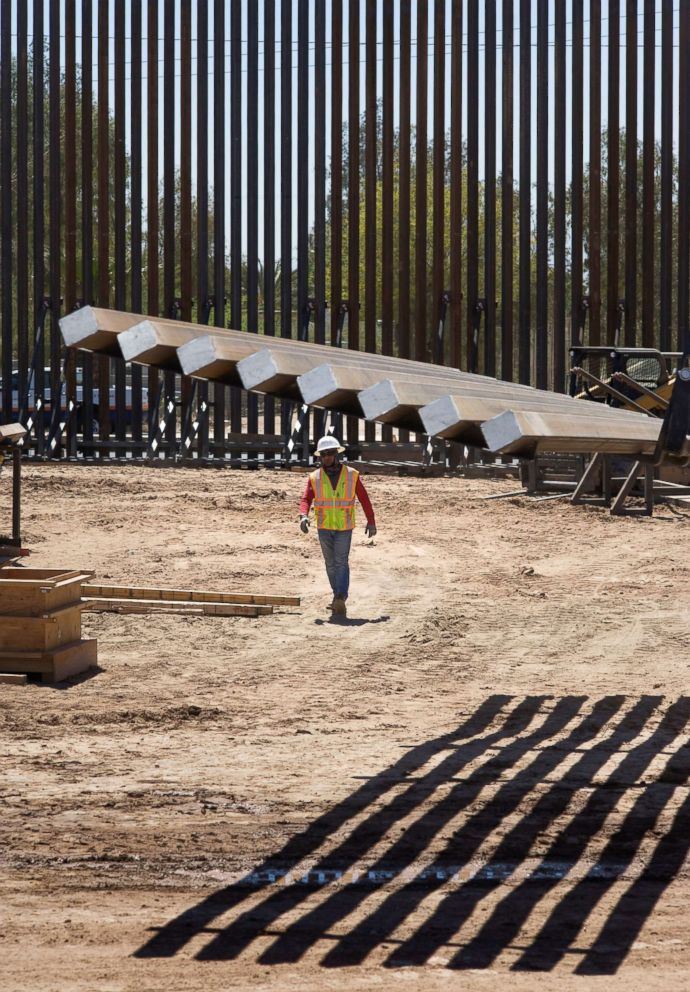 PHOTO: A construction workers walks near fencing at a section of the US-Mexico border wall that is being upgraded on April 18, 2018, in Calexico, Calif.