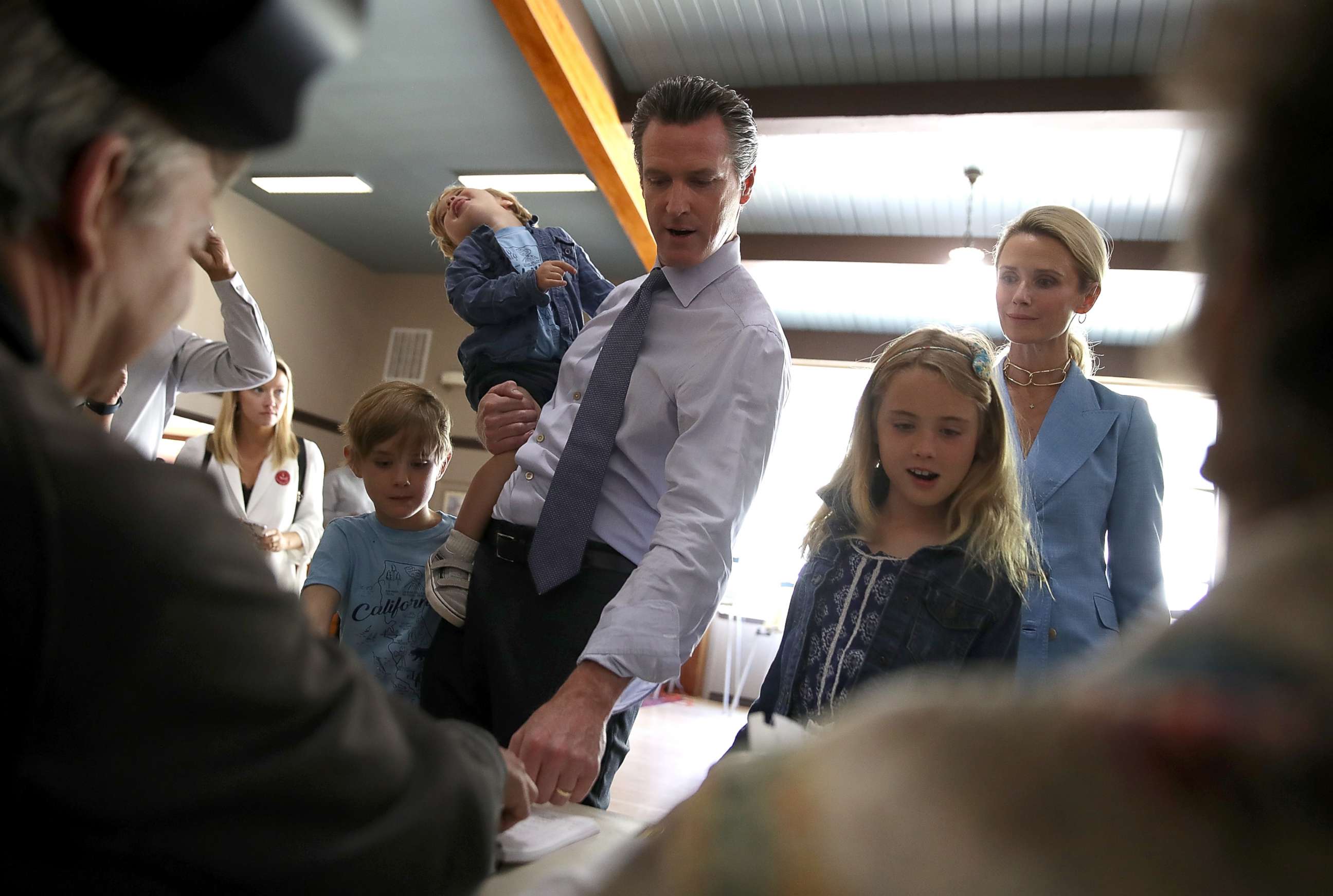 PHOTO: Democratic California gubernatorial candidate Lt. Gov. Gavin Newsom with his children and his wife, Jennifer Siebel Newsom sign in to vote at the Masonic Temple Fairfax on June 5, 2018 in Larkspur, California. 