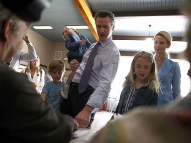 PHOTO: Democratic California gubernatorial candidate Lt. Gov. Gavin Newsom with his children and his wife, Jennifer Siebel Newsom sign in to vote at the Masonic Temple Fairfax on June 5, 2018 in Larkspur, California.