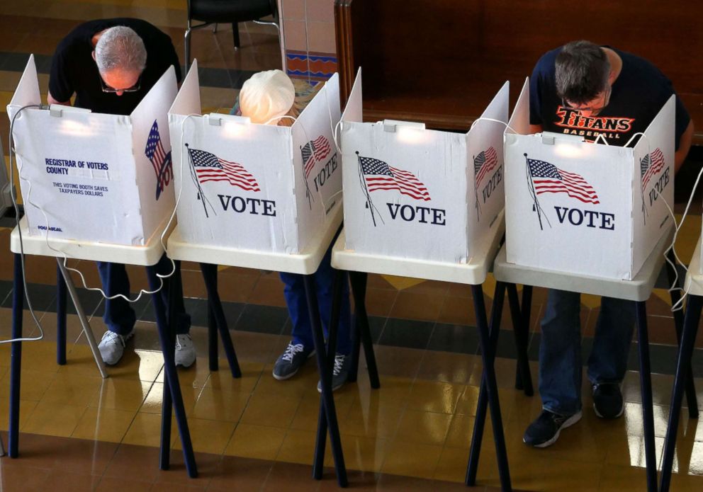 PHOTO: Voters mark their ballot at the Santa Monica City Hall polling station as Californians turned out for the state's primary elections, June 5, 2018. 