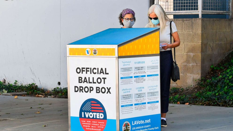 PHOTO: Voters cast their ballots for the 2020 US Elections at an offical ballot drop box on a sidewalk in Los Angeles, Oct. 12, 2020.