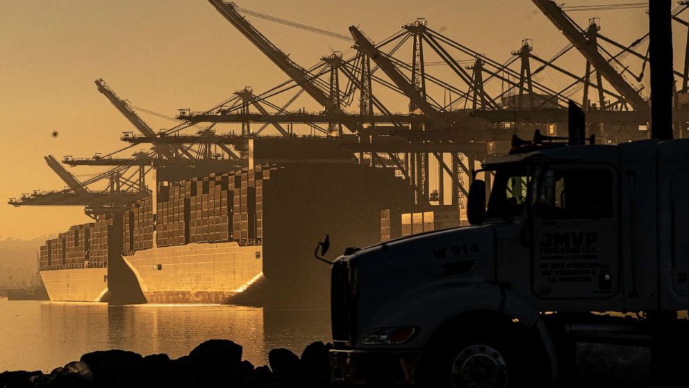 PHOTO: A truck arrives to pick up a shipping container near vessels moored at Maersk APM Terminals Pacific at the Port of Los Angeles, on Nov. 30, 2021.