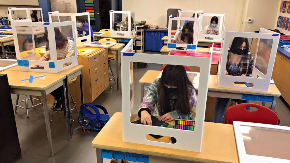 PHOTO: Students work on an art project during class, while socially distanced with protective partitions, at the Sinaloa Middle School in Novato, Calif.