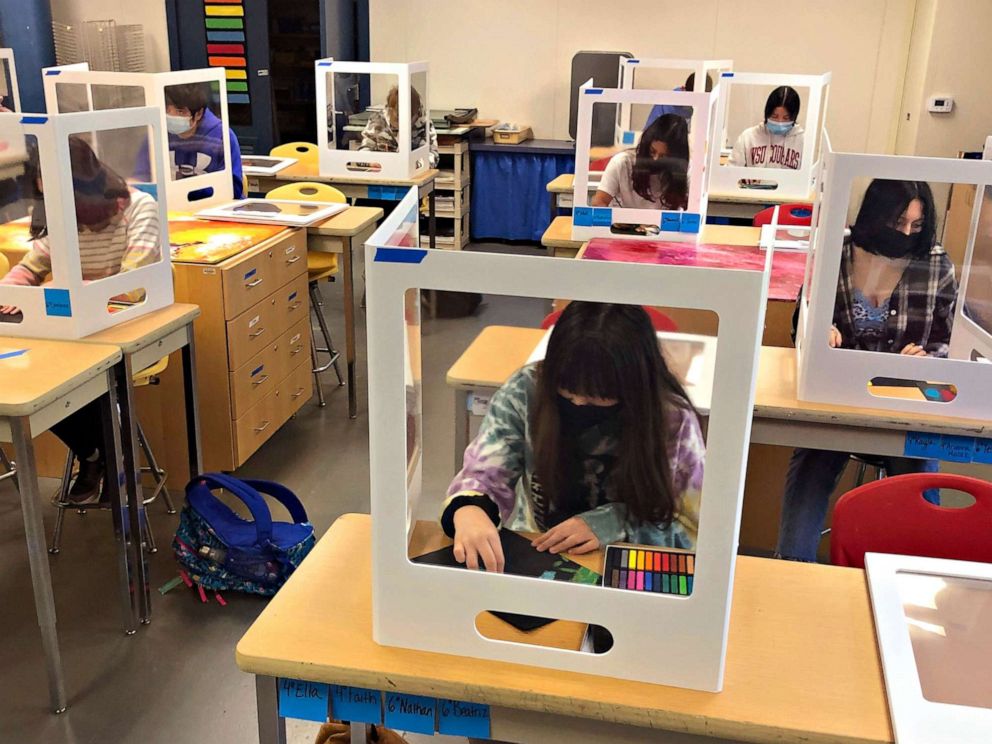 PHOTO: Students work on an art project during class, while socially distanced with protective partitions, at the Sinaloa Middle School in Novato, Calif., March 2, 2021.