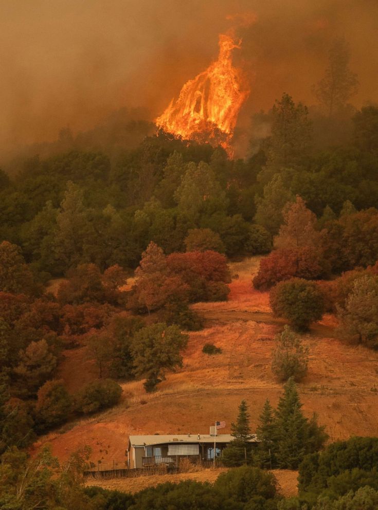 PHOTO: Towering flames approach a home during the Ranch Fire in Clearlake Oaks, Calif., Aug. 5, 2018.