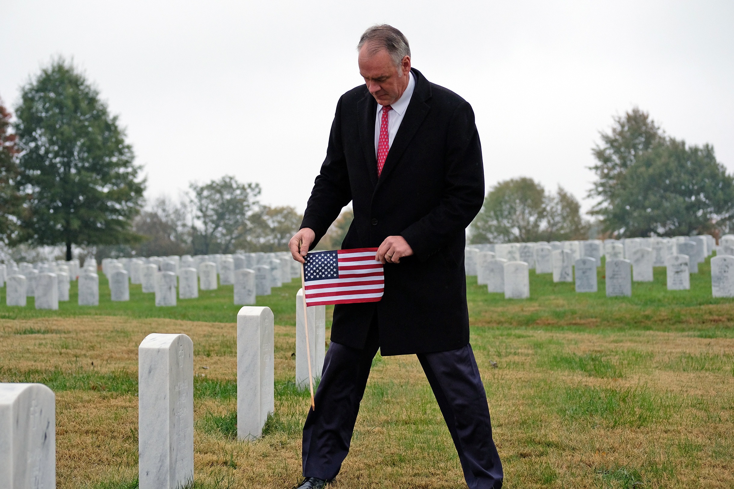 PHOTO: U.S. Interior Secretary Ryan Zinke holds a flag in the Camp Nelson National Cemetery in Nicholasville, Ky.