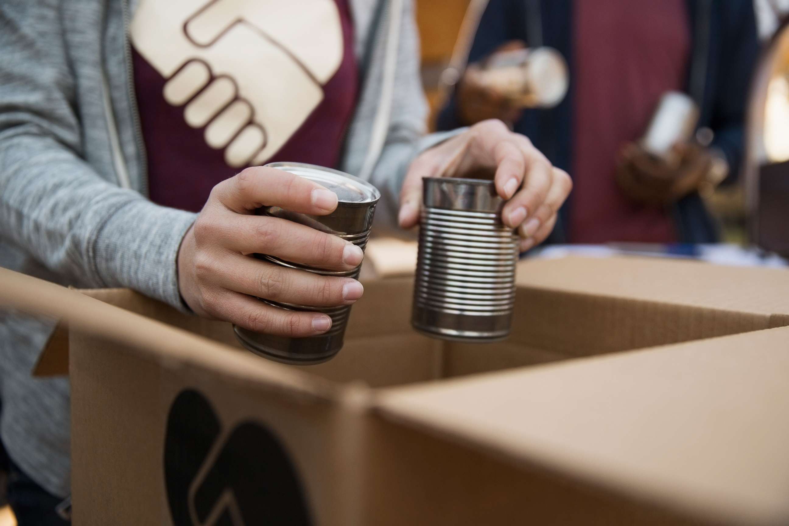 PHOTO: An undated stock photo depicts people packing boxes with canned food.