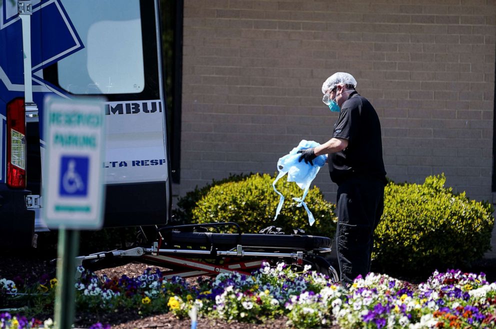 PHOTO: An ambulance worker is seen outside the Canterbury Rehabilitation & Healthcare Center in Richmond, Va., April 16, 2020.