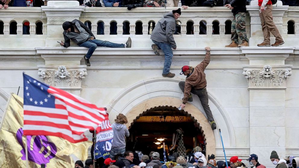PHOTO: A mob of supporters of President Donald Trump fight with members of law enforcement at a door they broke open as they storm the Capitol, Jan. 6, 2021. 