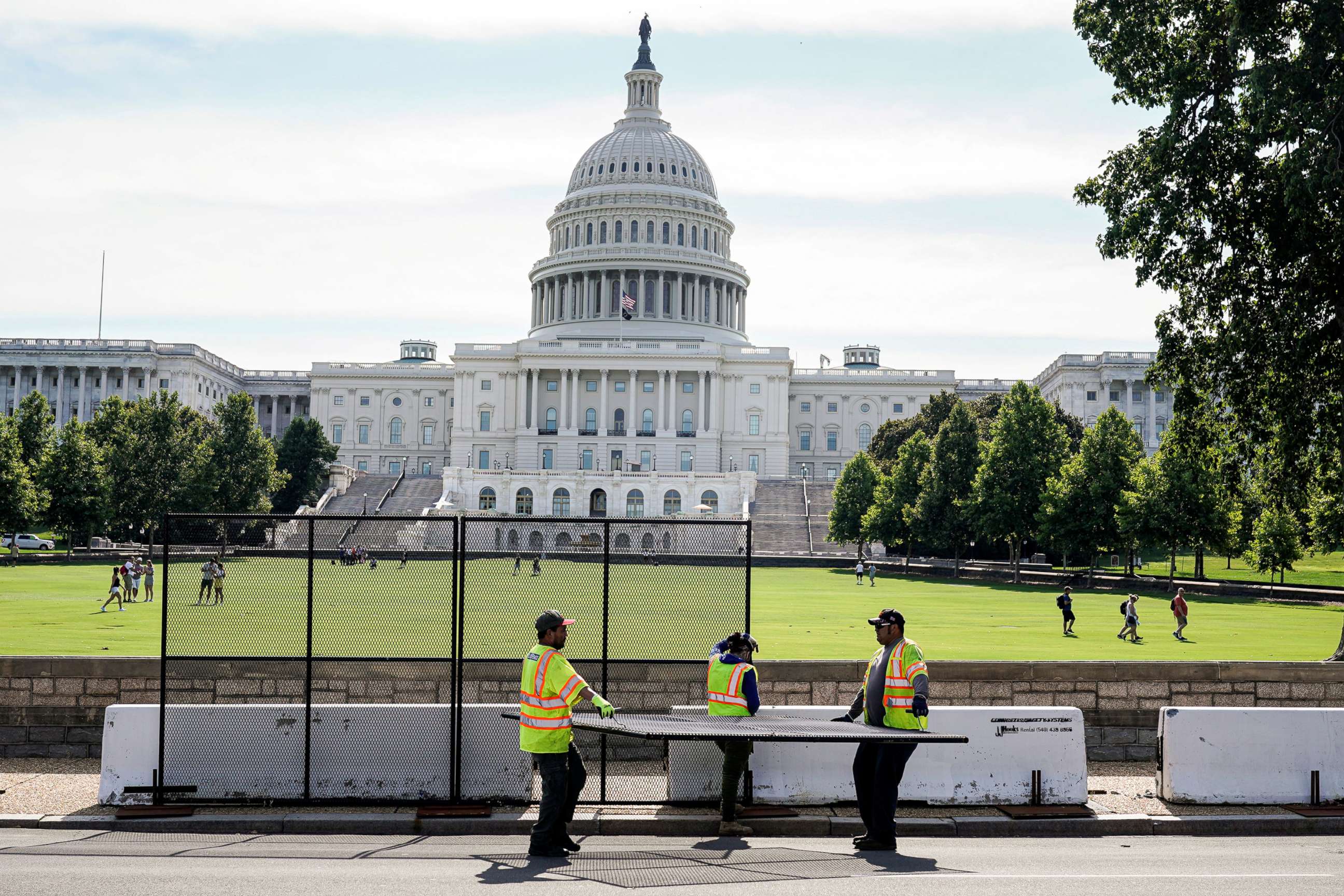 PHOTO: Workers remove security fencing as a reduction in heightened security measures  after the January 6th attack on the Capitol, July 10, 2021.