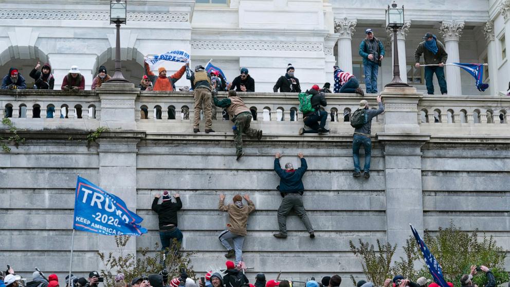PHOTO: Supporters of President Donald Trump climb the west wall of the U.S. Capitol in Washington, Jan. 6, 2021. 