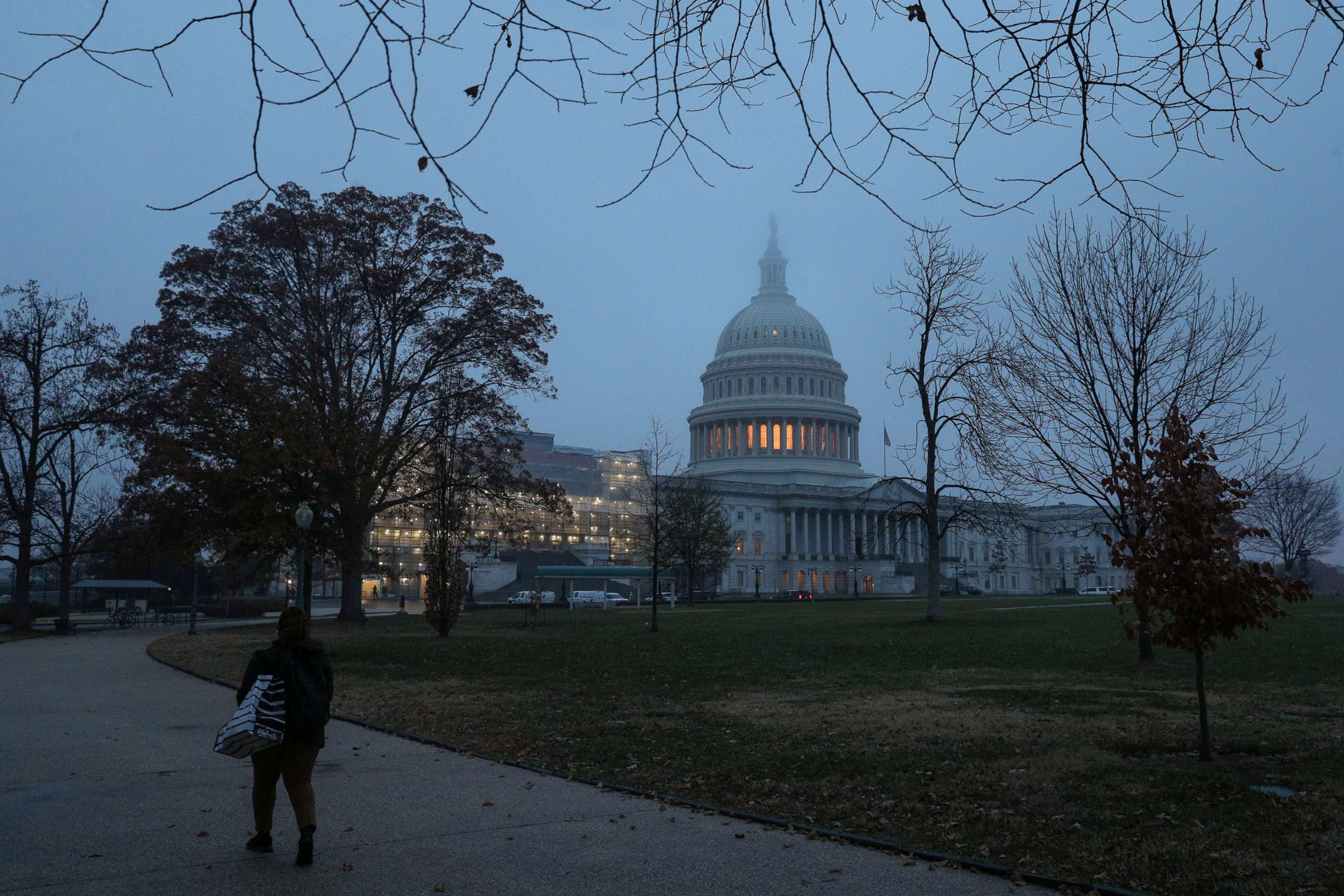 PHOTO: A woman walks past the U.S. Capitol dome early in the morning on another day of the continued impeachment inquiry hearings into President Donald Trump's dealings with Ukraine on Capitol Hill in Washington, D.C., Dec. 9, 2019.