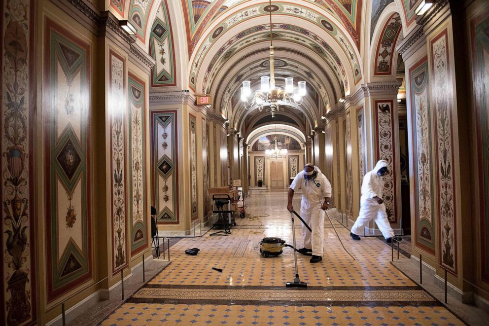 PHOTO: Workers clean damage near an overrun Capitol Police checkpoint a day after a pro-Trump mob broke into the U.S. Capitol, Jan. 7, 2021, in Washington, D.C.