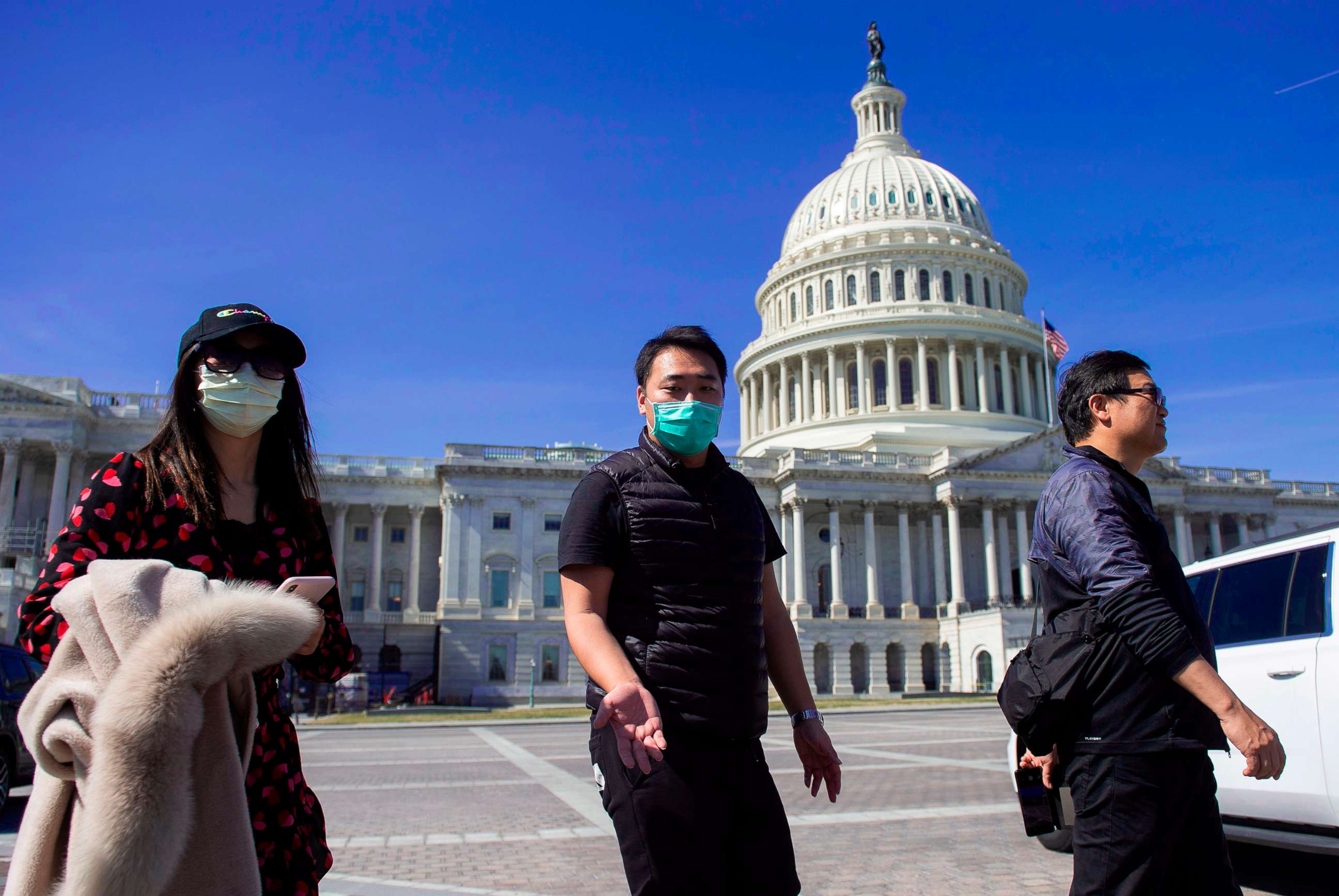 PHOTO: A tour operator, wearing a protective mask, gestures as he leads a tour near the Capitol in Washington,March 9, 2020. 
