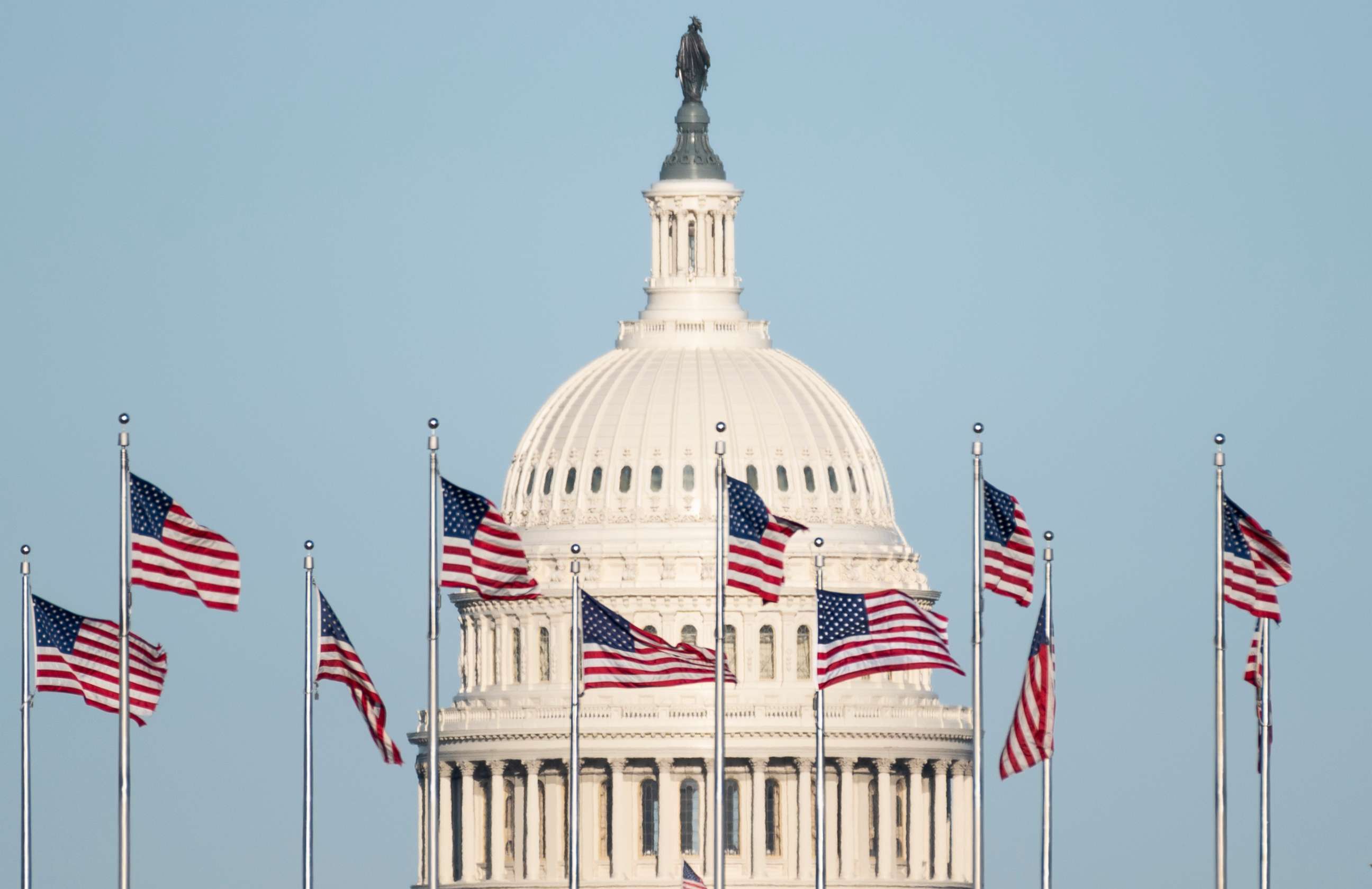 PHOTO: The U.S. Capitol dome is seen behind the American flags at the base of the Washington Monument in Washington, March 29, 2021.