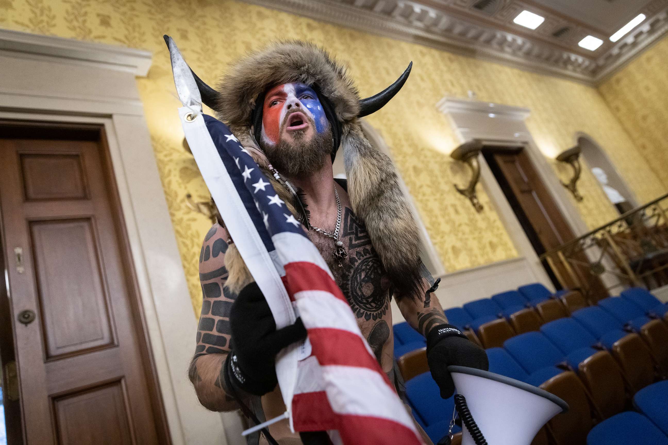 PHOTO: Jacob Chansley, also known as the "QAnon Shaman," screams "Freedom" inside the U.S. Senate chamber after the Capitol was breached by a mob during a joint session of Congress, Jan. 6, 2021.