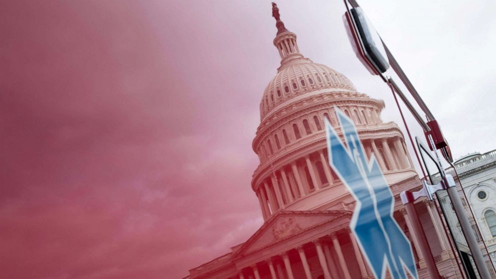 PHOTO: A view of the Capitol's Rotunda is seen reflected in an ambulance as negotiations on a COVID-19 economic bailout continue on Capitol Hill, March 24, 2020, in Washington.