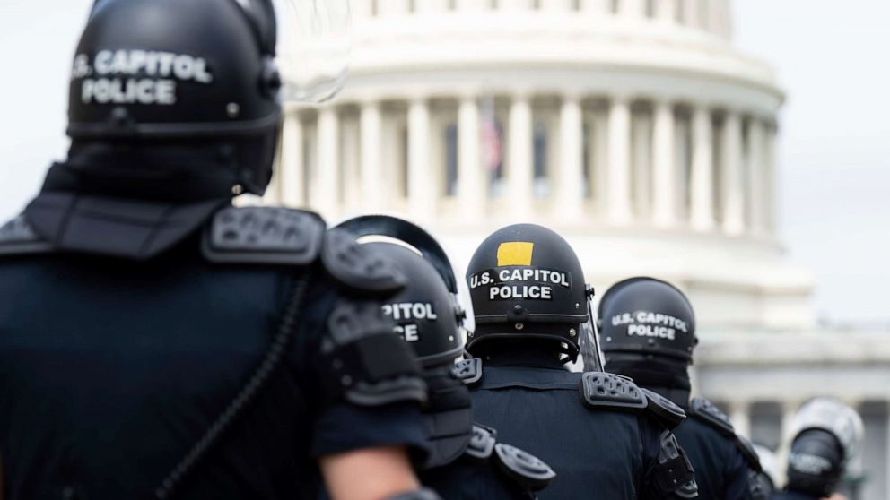 PHOTO: U.S. Capitol Police in riot gear return to their staging area after clear a path back to the Capitol, June 24, 2022.