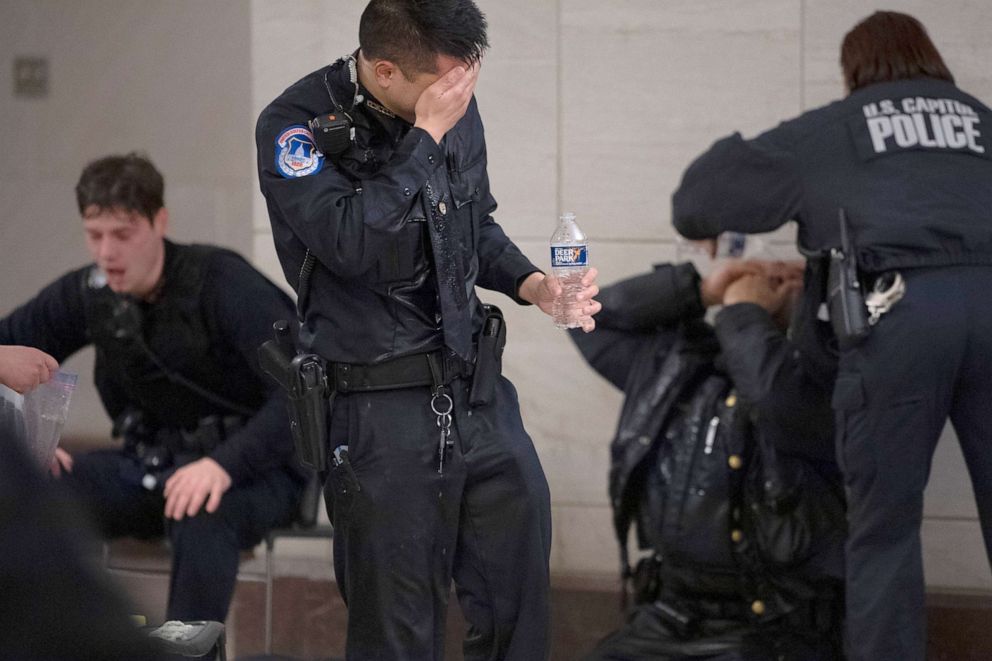 PHOTO: U.S. Capitol Police officers receive medical treatment after clashes with protesters who attempt to disrupt the joint session of Congress to certify the Electoral College vote in Washington, Jan. 6, 2021. 