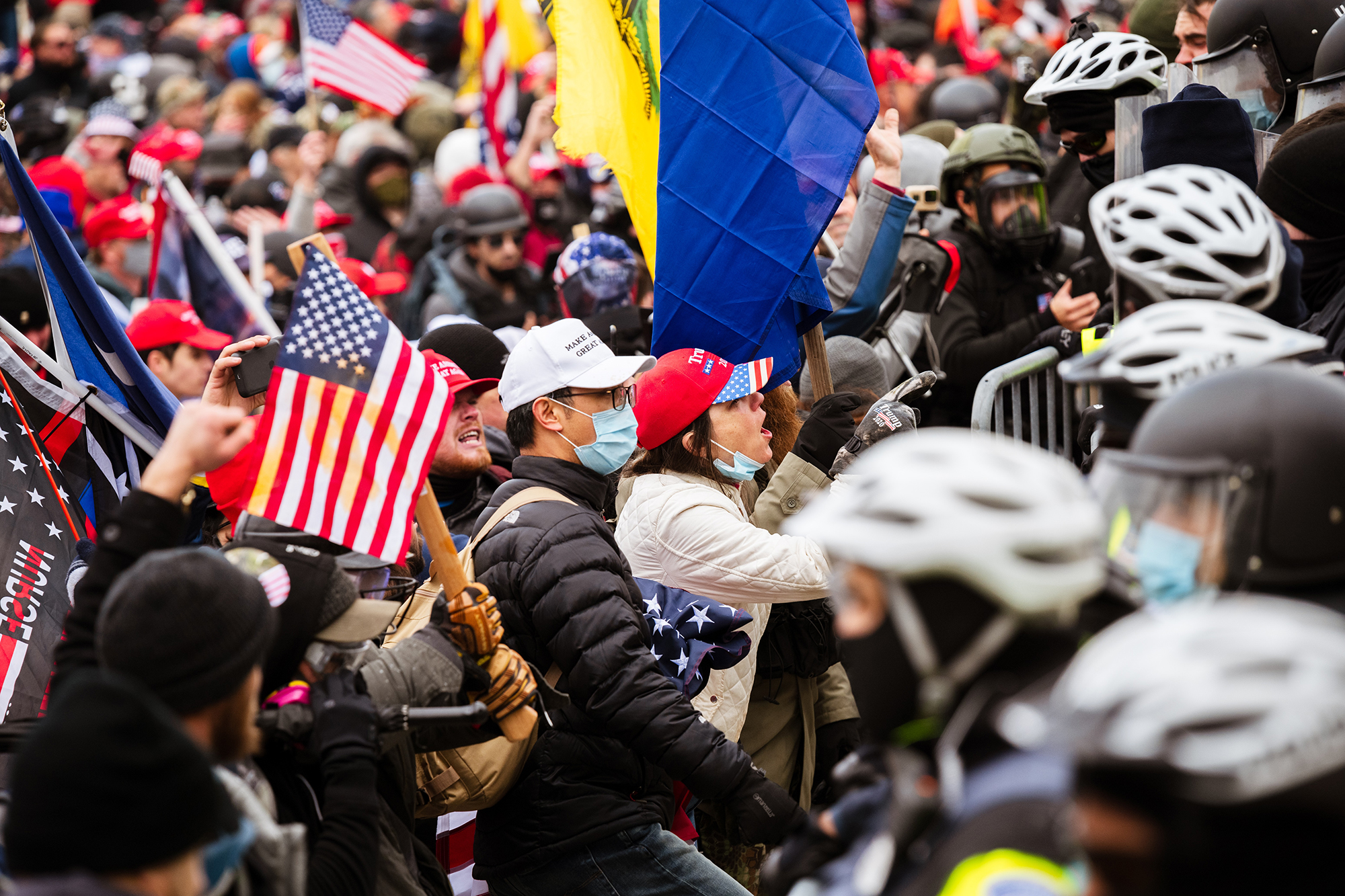 PHOTO: Pro-Trump protesters face a line of police officers after breaking through barriers onto the grounds of the Capitol Building, Jan. 6, 2021.