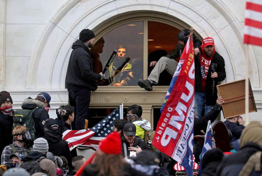 PHOTO: A mob of Trump supporters climb through a window they broke during the seige of the U.S. Capitol in Washington, D.C., Jan. 6, 2021.