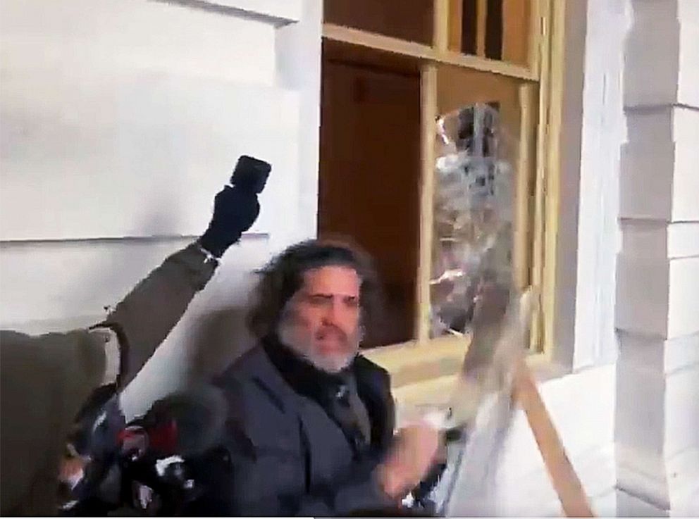 PHOTO: Video captures Dominic Pezzola hitting a window at the Capitol building as supporters of President Donald Trump breach security in Washington, Jan. 6, 2021.