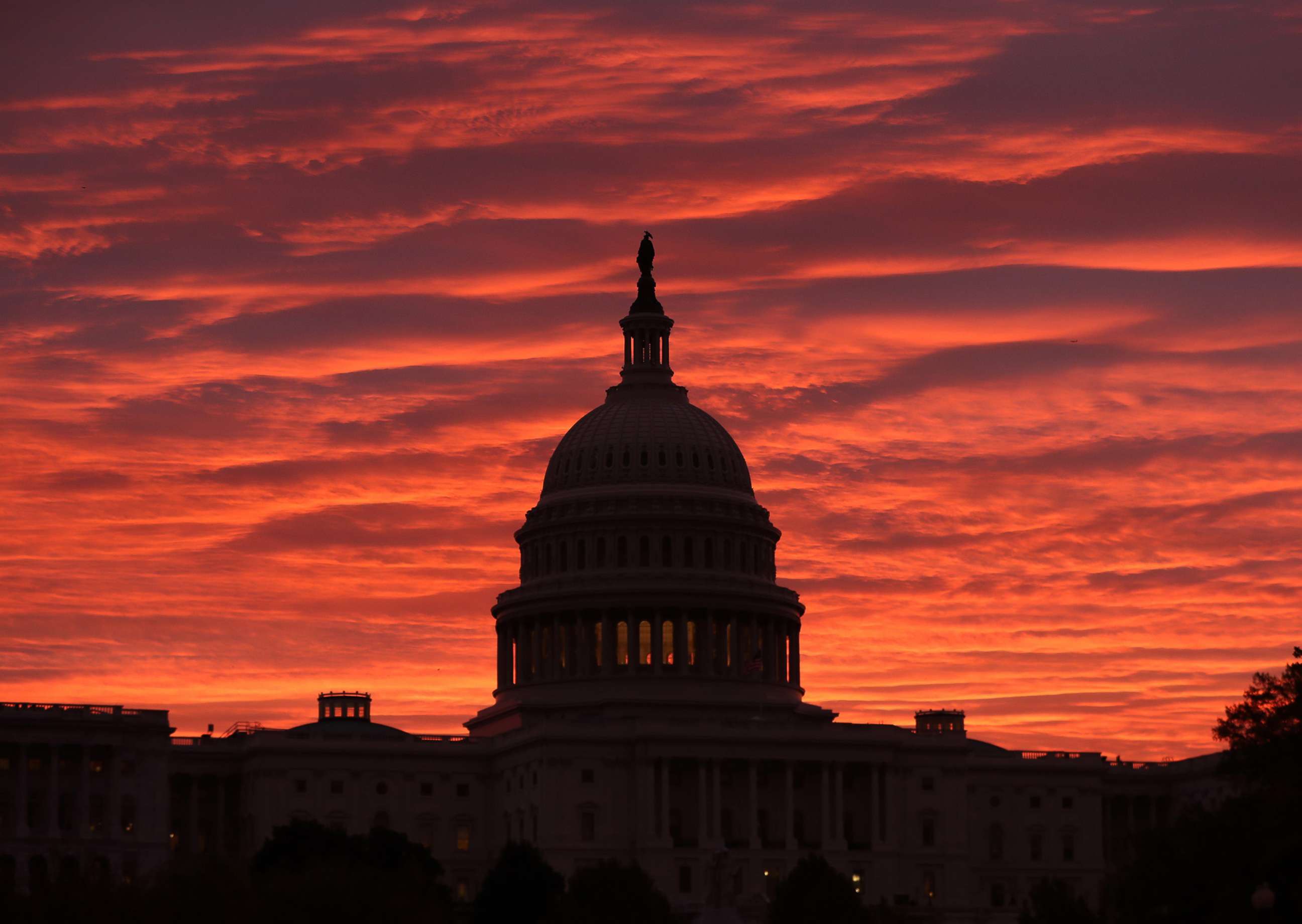 PHOTO: A red sky as the sun begins to rise behind the U.S. Capitol building, Nov. 7, 2019 in Washington, D.C.