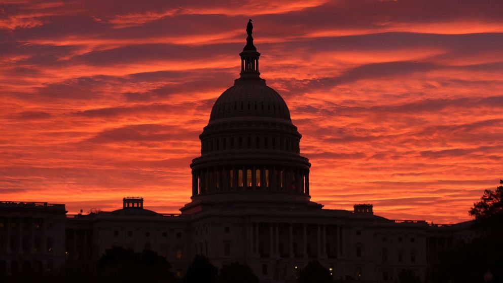 PHOTO: A red sky as the sun begins to rise behind the U.S. Capitol building, Nov. 7, 2019 in Washington, D.C.