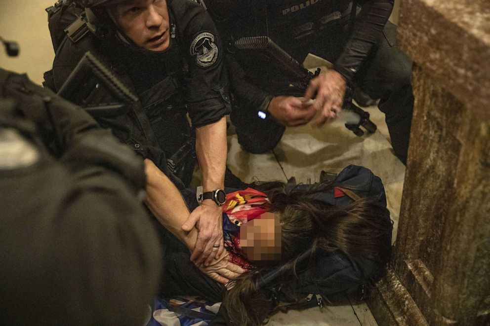 PHOTO: Ashley Babbitt lies on the ground after being shot inside the U.S. Capitol as people stormed the building in Washington on Jan. 6, 2021. Babbitt died.