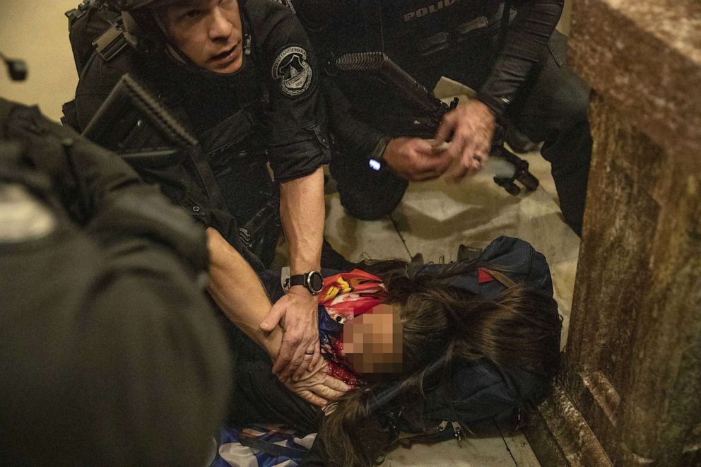 PHOTO: A person lies on the ground after being shot during a protest at the U.S. Capitol in Washington, D.C., on Jan. 6, 2021. The U.S. Capitol was placed under lockdown as hundreds of protesters swarmed past barricades surrounding the building.