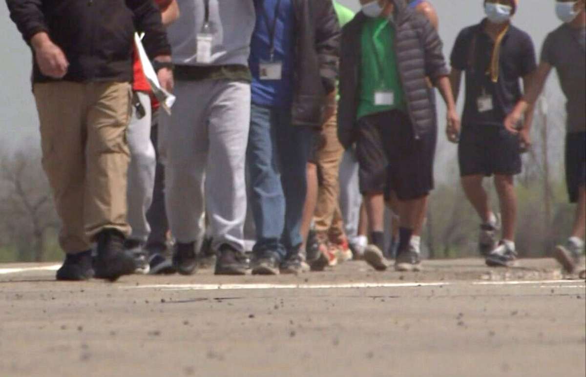 PHOTO: Unaccompanied immigrant children are seen walking across a parking lot at Carrizo Springs Influx Care Facility for unaccompanied immigrant children in Carrizo Springs, Texas, March 24, 2021. 