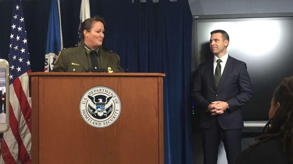 Carla Provost speaks to reporters in Washington after being appointed chief of the U.S. Border Patrol by Customs and Border Protection Commissioner Kevin McAleenan, seen standing behind her. Aug. 9, 2018.